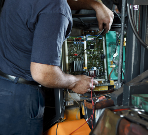 Service tech working on forklift